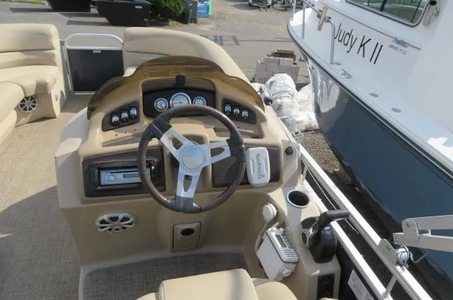 Slide: The Image of 2014 Bennington 2275 GCW boat dashboard with steering wheel and control panel. - 15