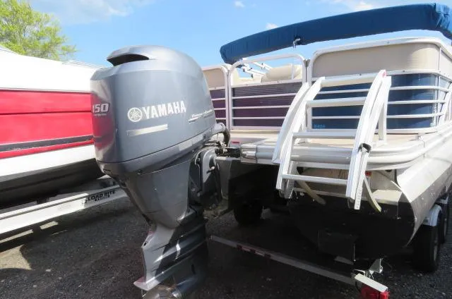 Slide: The Image of 2014 Bennington 2275 GCW pontoon boat with Yamaha 150 outboard motor, docked outdoors. - 5