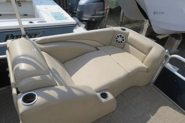 Slide: The Image of 2014 Bennington 2275 GCW boat interior with beige seating and cup holders. - 7