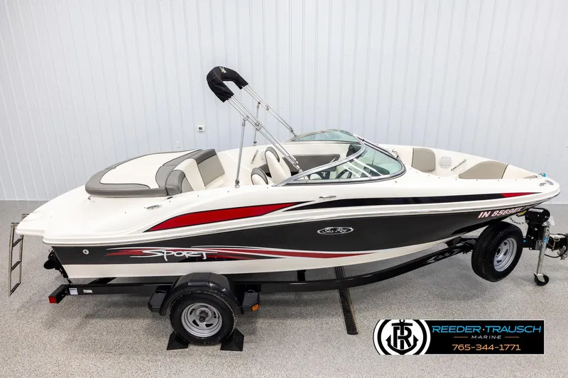 Slide: The Image of 2011 Sea Ray 185 Sport boat on trailer, side view, in showroom setting. - 1