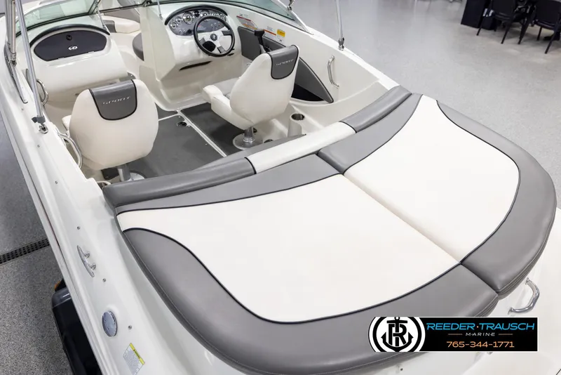 Slide: The Image of 2011 Sea Ray 185 Sport boat interior with white and gray seating, steering wheel, and dashboard. - 11