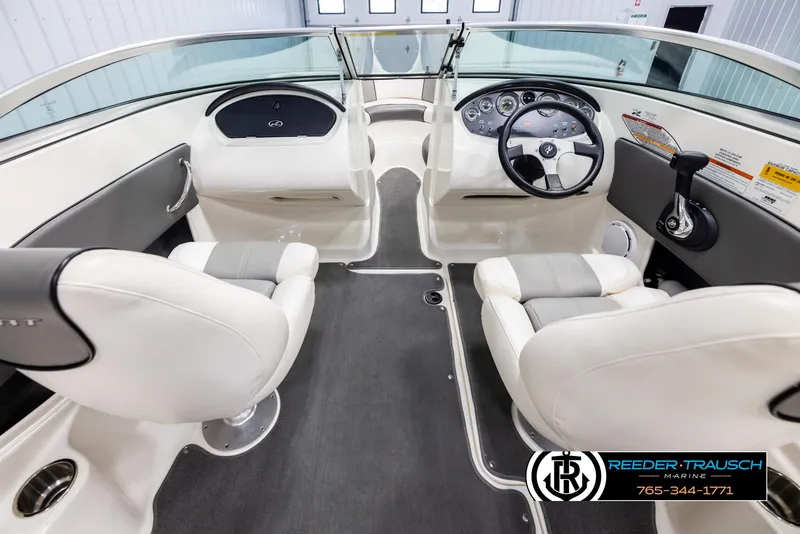 Slide: The Image of 2011 Sea Ray 185 Sport boat interior with steering wheel and seating. - 14
