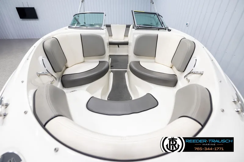 Slide: The Image of 2011 Sea Ray 185 Sport boat interior with gray and white seating. - 17
