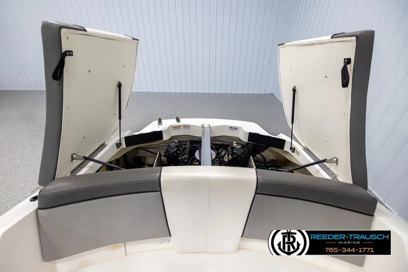 Slide: The Image of 2011 Sea Ray 185 Sport boat engine compartment with open hatches in showroom. - 22