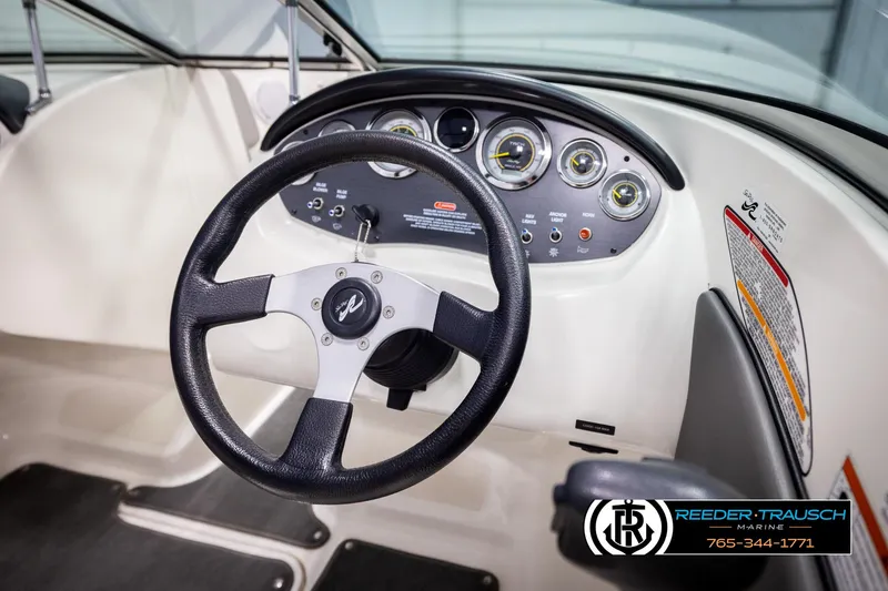 Slide: The Image of 2011 Sea Ray 185 Sport dashboard with steering wheel and instrument panel. - 25