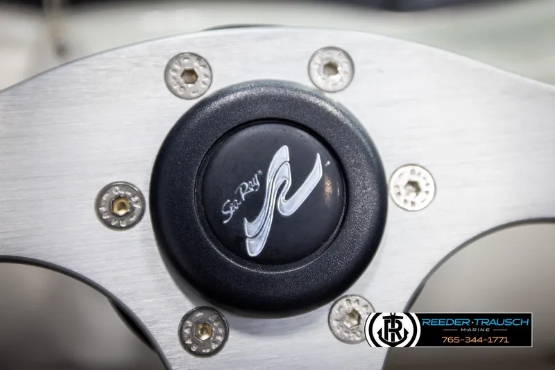 Slide: The Image of Steering wheel center of 2011 Sea Ray 185 Sport boat with logo and branding. - 27
