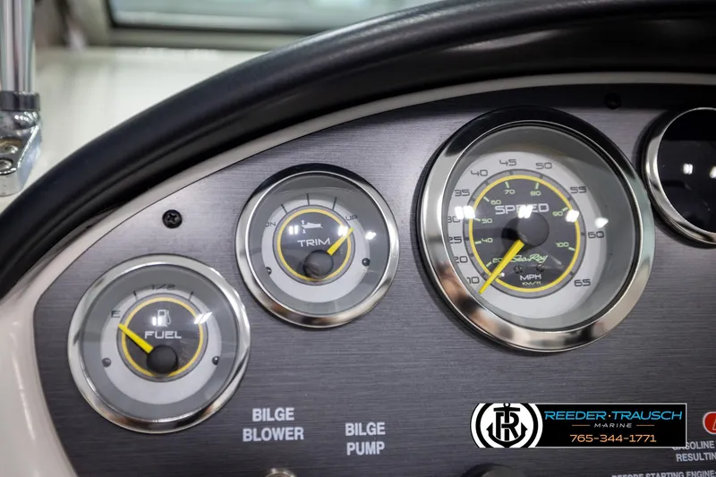 Slide: The Image of Dashboard of 2011 Sea Ray 185 Sport boat with fuel, trim, and speed gauges. - 29
