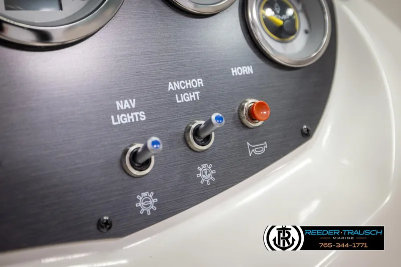 Slide: The Image of Control panel of 2011 Sea Ray 185 Sport boat with switches for lights and horn. - 31