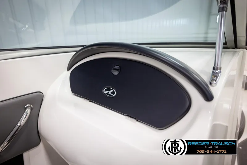 Slide: The Image of 2011 Sea Ray 185 Sport boat dashboard with glove compartment and logo. - 36