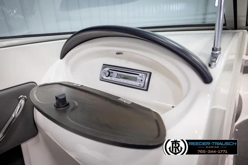 Slide: The Image of 2011 Sea Ray 185 Sport boat dashboard with stereo system and storage compartment. - 37