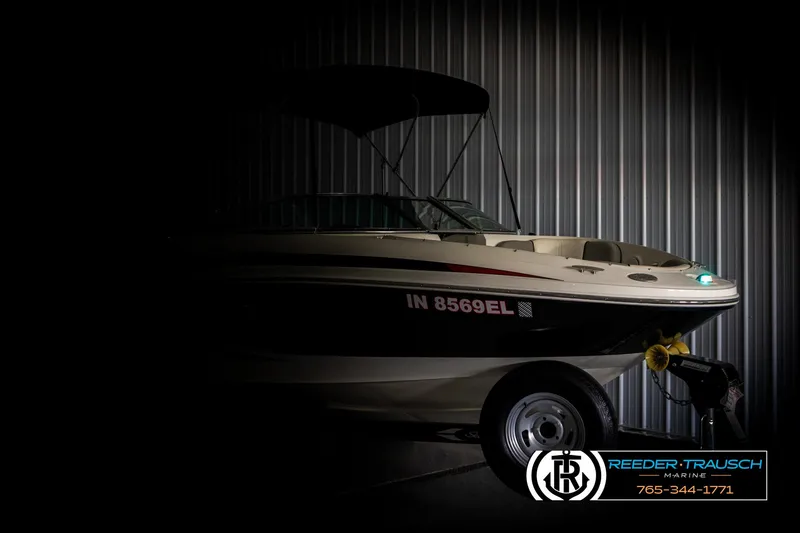 Slide: The Image of 2011 Sea Ray 185 Sport boat in dimly lit storage, side view. - 4