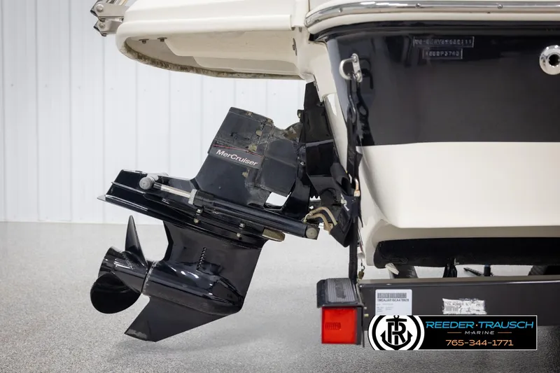 Slide: The Image of 2011 Sea Ray 185 Sport boat stern with MerCruiser outdrive, displayed in a showroom. - 43