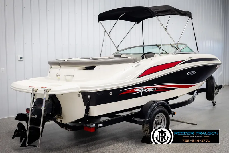 Slide: The Image of 2011 Sea Ray 185 Sport boat with trailer, featuring sleek design and bimini top. - 6