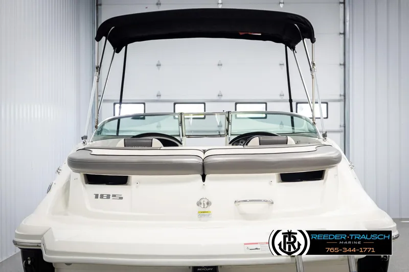 Slide: The Image of 2011 Sea Ray 185 Sport boat with black canopy in a garage setting. - 7