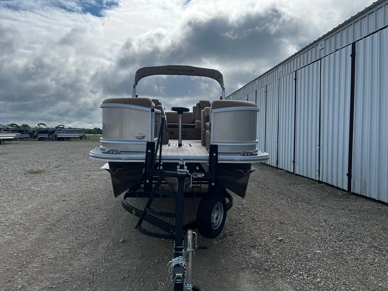 Slide: The Image of 2025 SunCatcher Fusion 324SL pontoon boat on trailer, parked outdoors. - 2