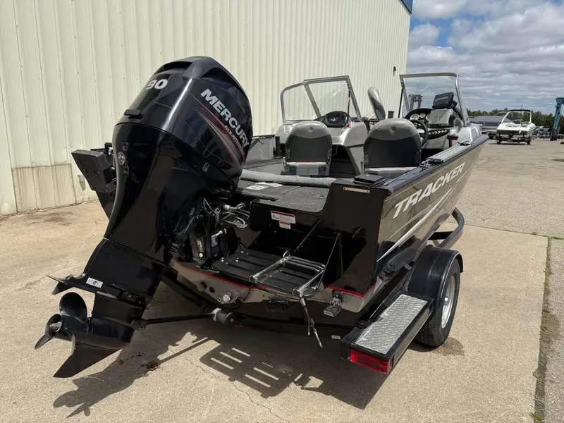 Slide: The Image of 2014 Tracker Pro Guide V-175 WT boat with Mercury engine, parked outdoors. - 5