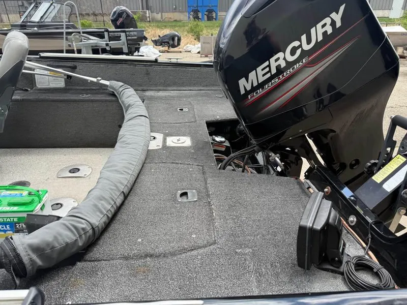 Slide: The Image of 2014 Tracker Pro Guide V-175 WT boat with Mercury FourStroke engine, outdoor setting. - 7