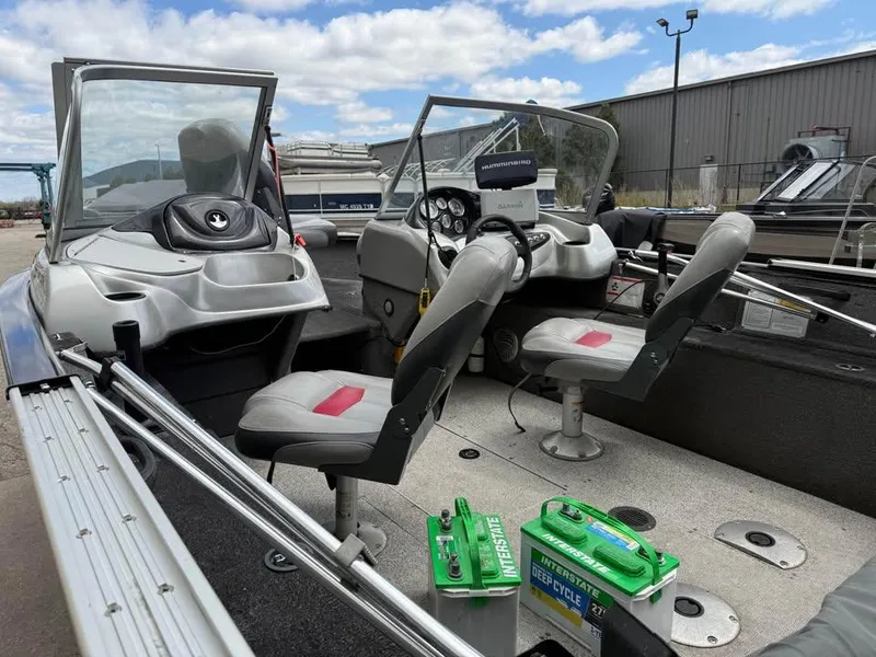 Slide: The Image of 2014 Tracker Pro Guide V-175 WT boat interior with seats and marine battery. - 8