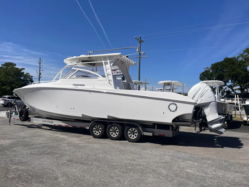 Slide: The Image of 2021 Fountain 38 SFC boat on trailer under clear blue sky. - 18
