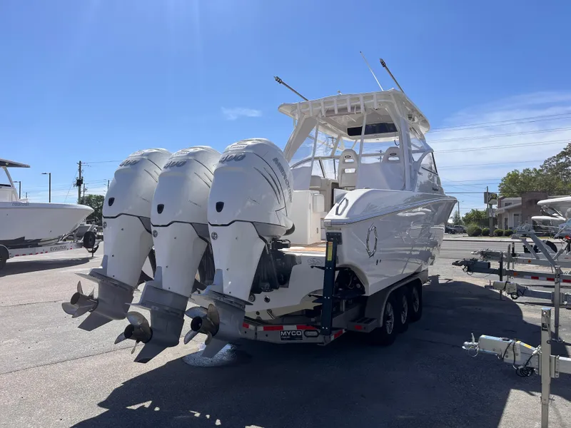 Slide: The Image of 2021 Fountain 38 SFC boat with triple outboard engines on a trailer. - 20