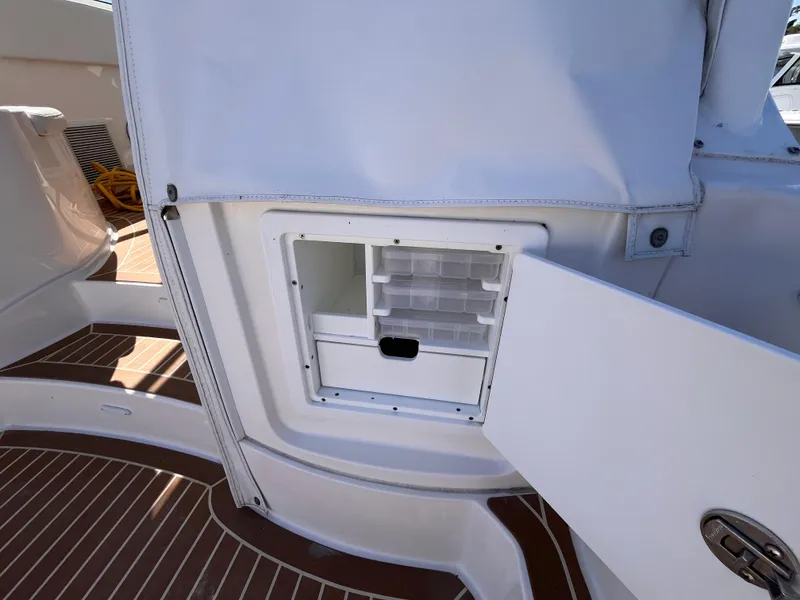 Slide: The Image of Open storage compartment on 2021 Fountain 38 SFC boat, featuring organized interior shelves. - 25