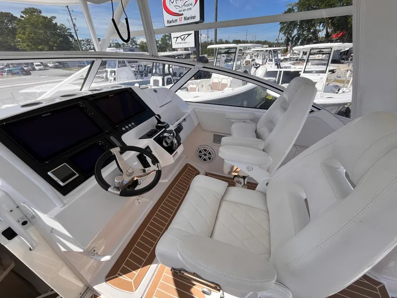 Slide: The Image of Cockpit of 2021 Fountain 38 SFC boat with white seating and modern controls. - 30