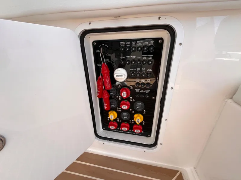 Slide: The Image of Electrical panel on a 2021 Fountain 38 SFC boat, featuring switches and safety keys. - 31