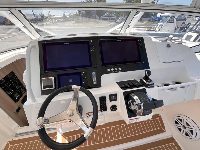 Slide: The Image of Helm of 2021 Fountain 38 SFC boat with dual screens and modern controls. - 32