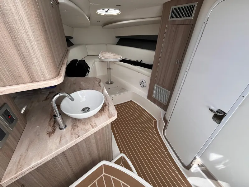 Slide: The Image of 2021 Fountain 38 SFC cabin interior with sink, seating, and wooden flooring. - 34