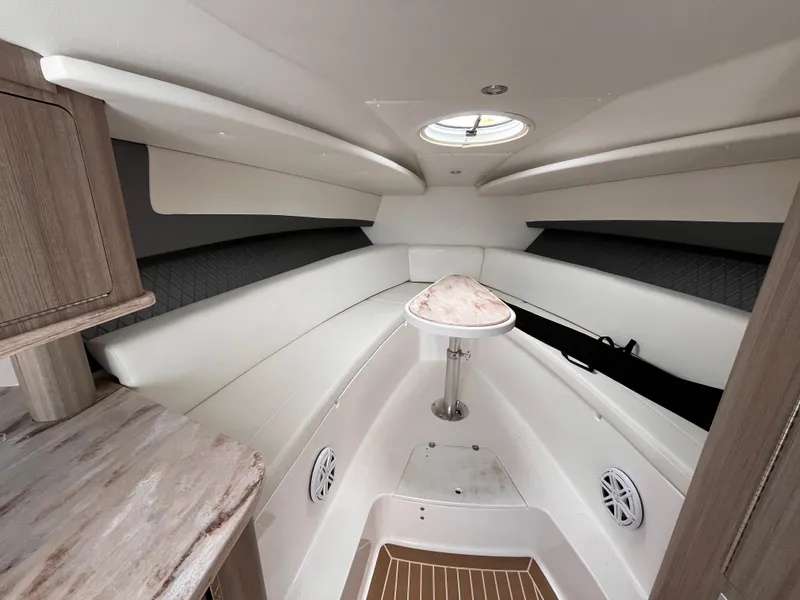 Slide: The Image of 2021 Fountain 38 SFC boat interior with white seating and wood accents. - 36