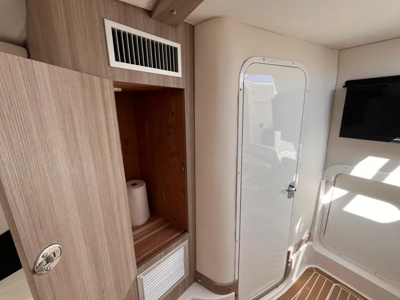 Slide: The Image of 2021 Fountain 38 SFC interior with wooden cabinetry, door, and wall-mounted TV. - 37