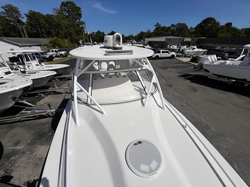 Slide: The Image of 2021 Fountain 38 SFC boat on display at a dealership, surrounded by other boats. - 43