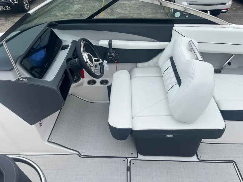 Slide: The Image of 2025 Regal LS6 boat interior with white seating and modern dashboard. - 13