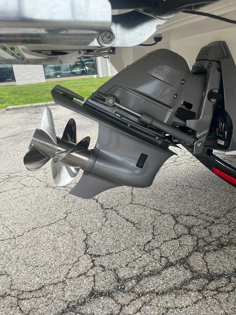 Slide: The Image of 2025 Regal LS6 boat propeller and outdrive on pavement. - 14