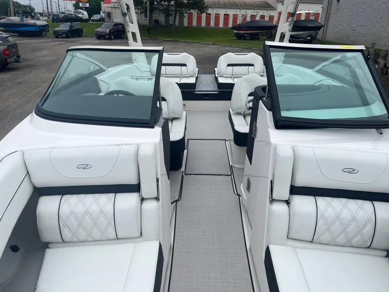 Slide: The Image of 2025 Regal LS6 boat interior with white leather seating and dual consoles. - 4