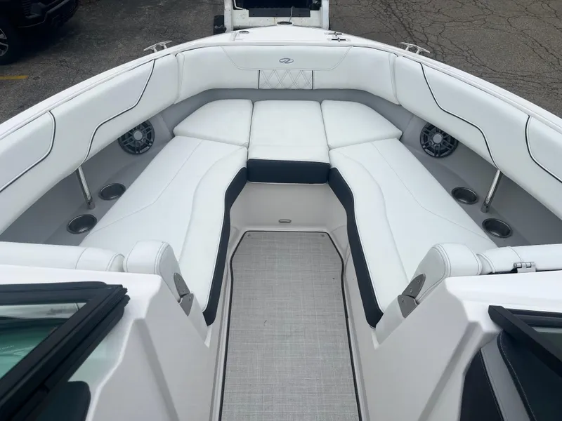 Slide: The Image of 2025 Regal LS6 boat interior with white cushioned seating and modern design. - 5