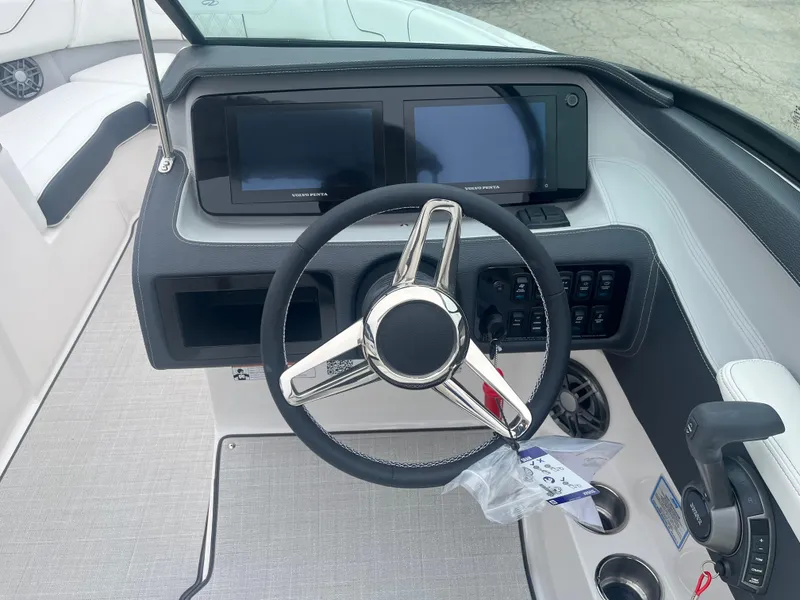 Slide: The Image of 2025 Regal LS6 boat dashboard with dual screens and steering wheel. - 9