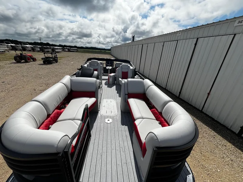 Slide: The Image of 2025 SunCatcher Elite 324 RC pontoon boat with spacious seating, docked outdoors. - 13