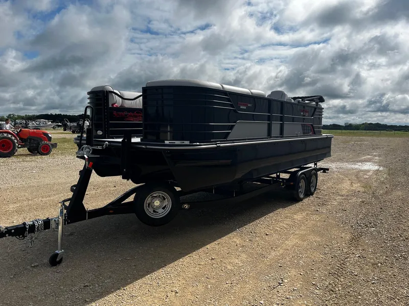 Slide: The Image of 2025 SunCatcher Elite 324 RC pontoon boat on trailer under cloudy sky. - 3