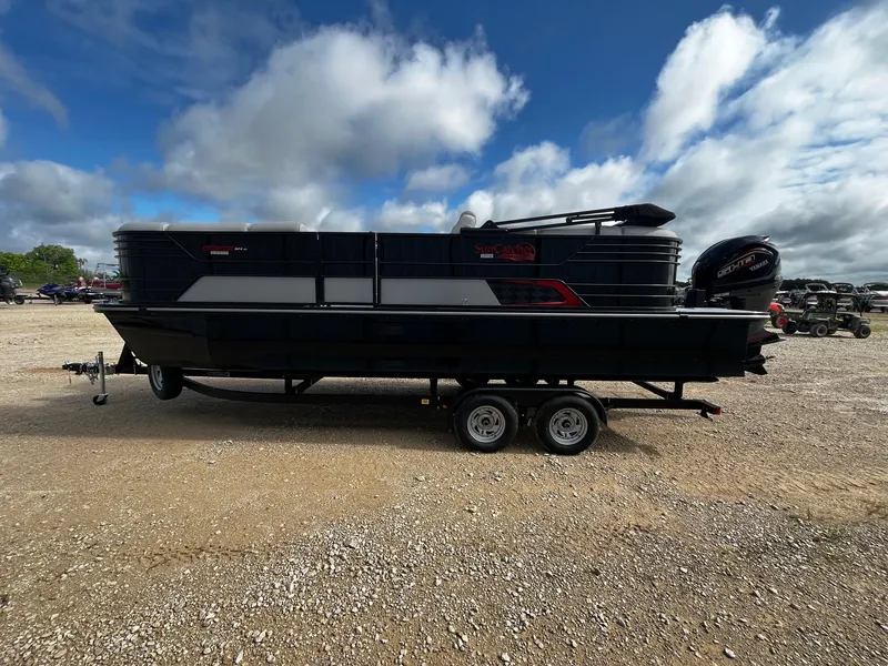 Slide: The Image of 2025 SunCatcher Elite 324 RC pontoon boat on trailer under cloudy sky. - 4