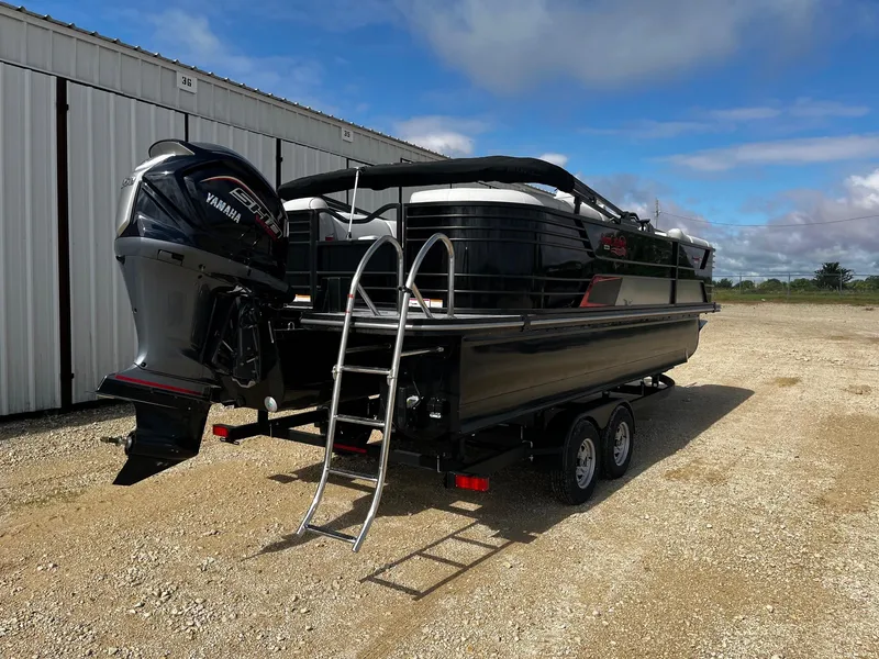 Slide: The Image of 2025 SunCatcher Elite 324 RC pontoon boat on trailer, featuring Yamaha outboard motor. - 7