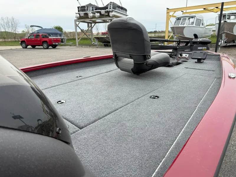 Slide: The Image of 2022 Tracker Pro Team 190 TX boat with spacious deck and seating, parked outdoors. - 12