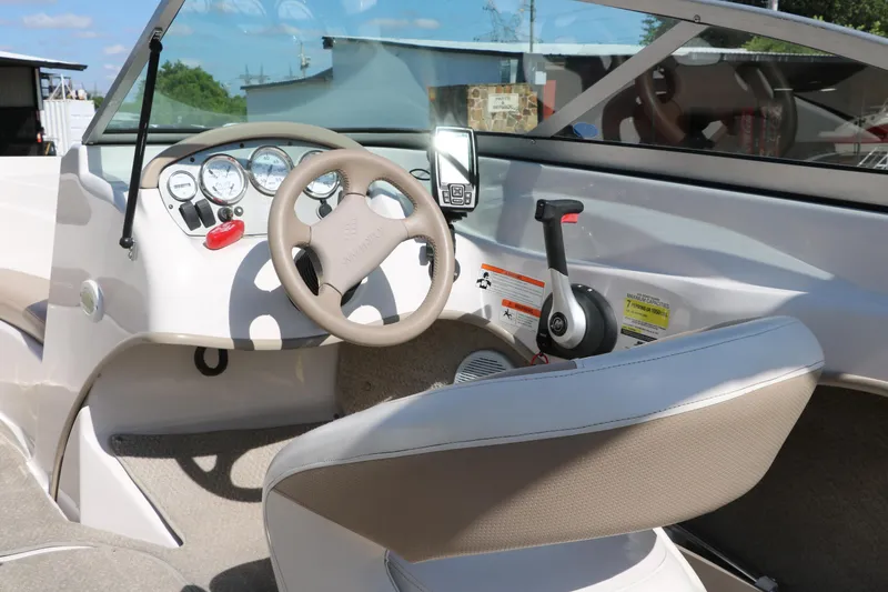 Slide: The Image of 2006 Four Winns 180 Horizon boat interior with steering wheel and control panel. - 13