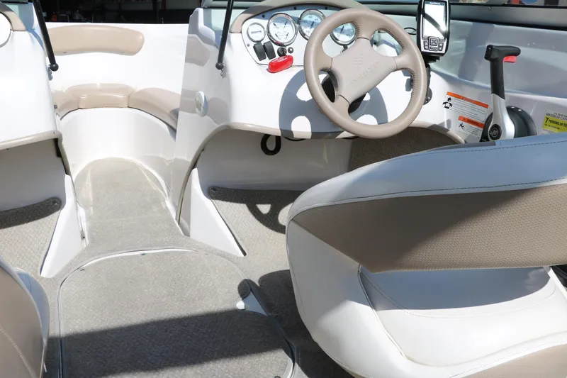 Slide: The Image of 2006 Four Winns 180 Horizon boat interior with steering wheel and dashboard controls. - 14
