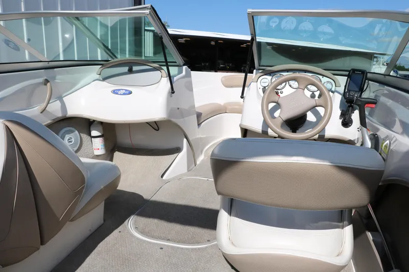 Slide: The Image of 2006 Four Winns 180 Horizon boat interior with steering wheel and seating. - 16