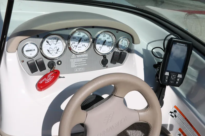Slide: The Image of Dashboard of a 2006 Four Winns 180 Horizon boat with gauges and navigation system. - 22