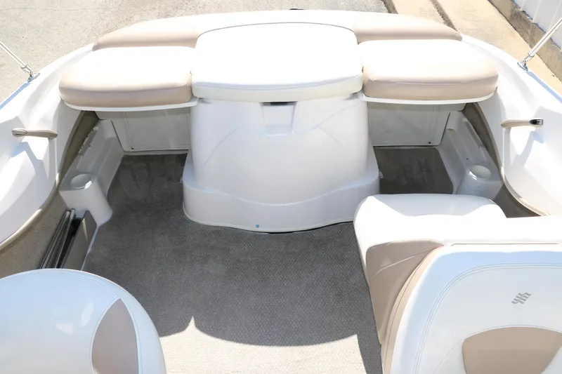 Slide: The Image of 2006 Four Winns 180 Horizon boat interior with beige seating and carpeted floor. - 25