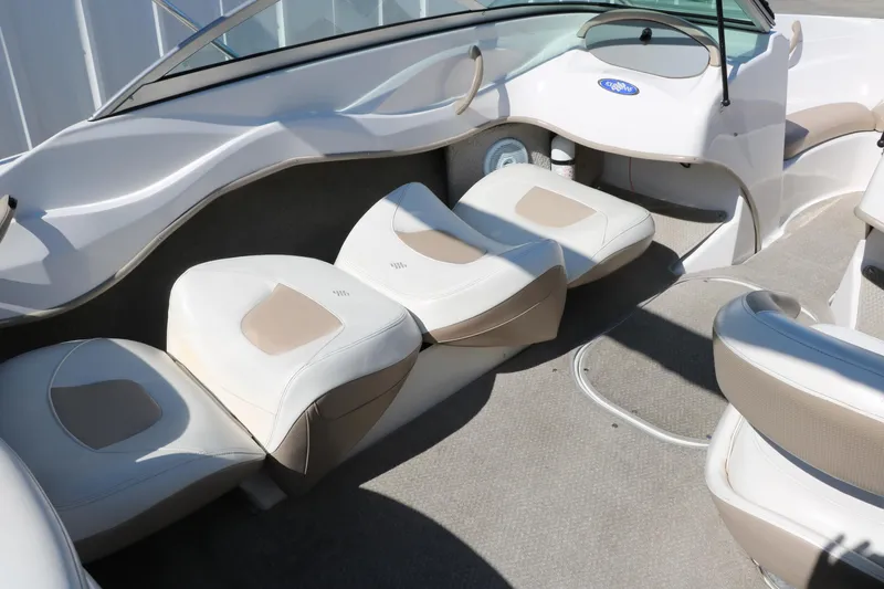 Slide: The Image of 2006 Four Winns 180 Horizon boat interior with beige seating and carpeted floor. - 26
