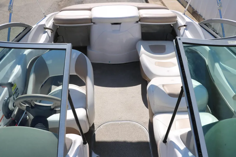 Slide: The Image of 2006 Four Winns 180 Horizon boat interior with seating and steering wheel. - 27