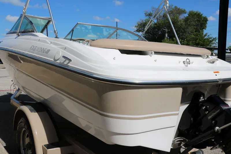 Slide: The Image of 2006 Four Winns 180 Horizon boat on trailer, beige and white exterior, sunny day. - 5